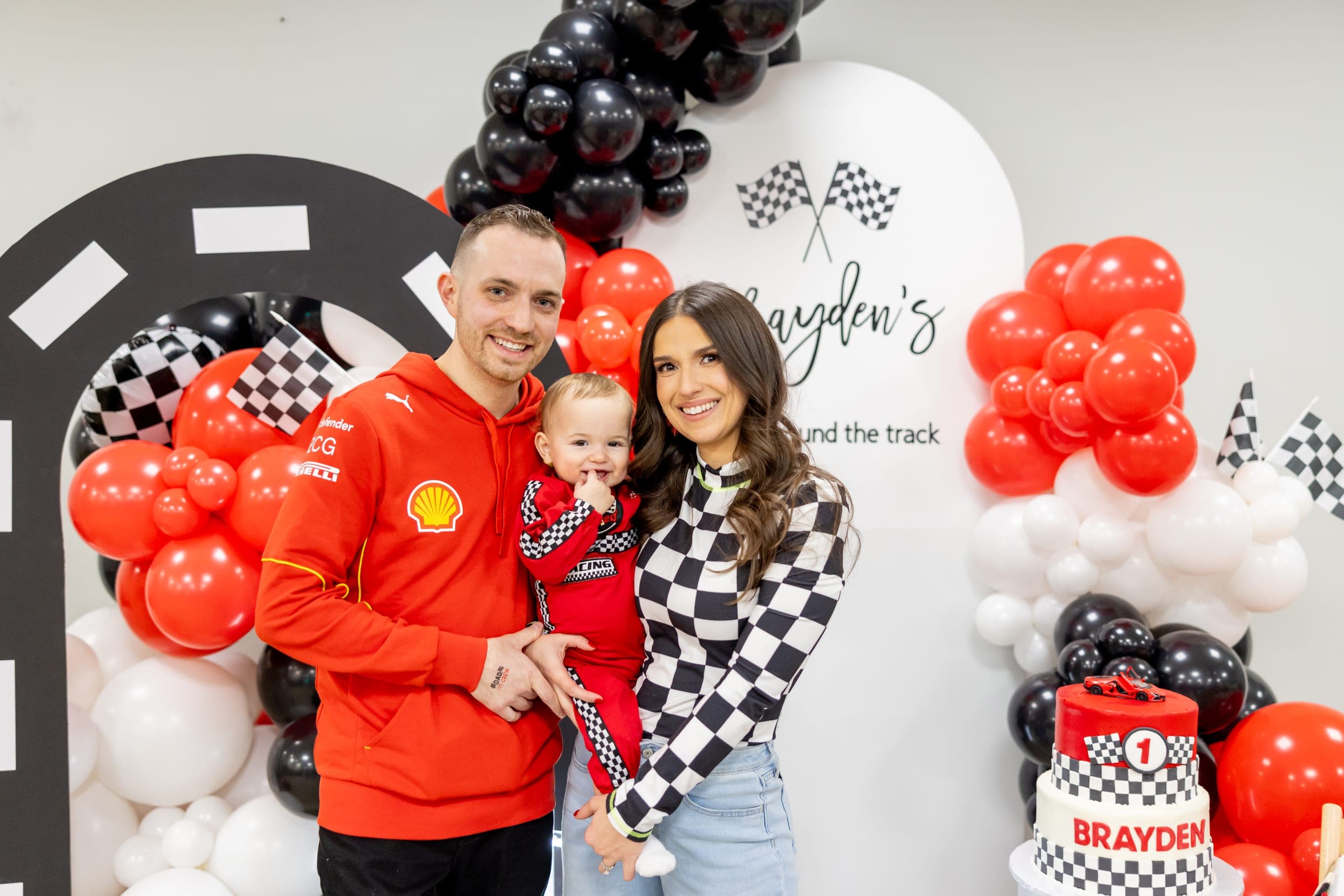 Chris, Shantelle, and Brayden at Brayden's racing-themed first birthday party