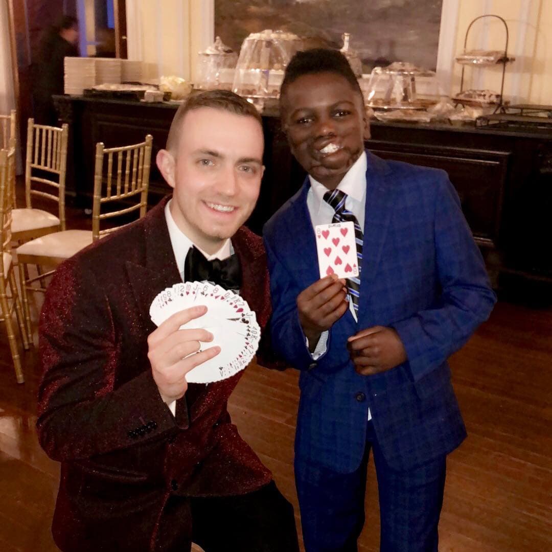 Chris Dare performing magic for children at a community event