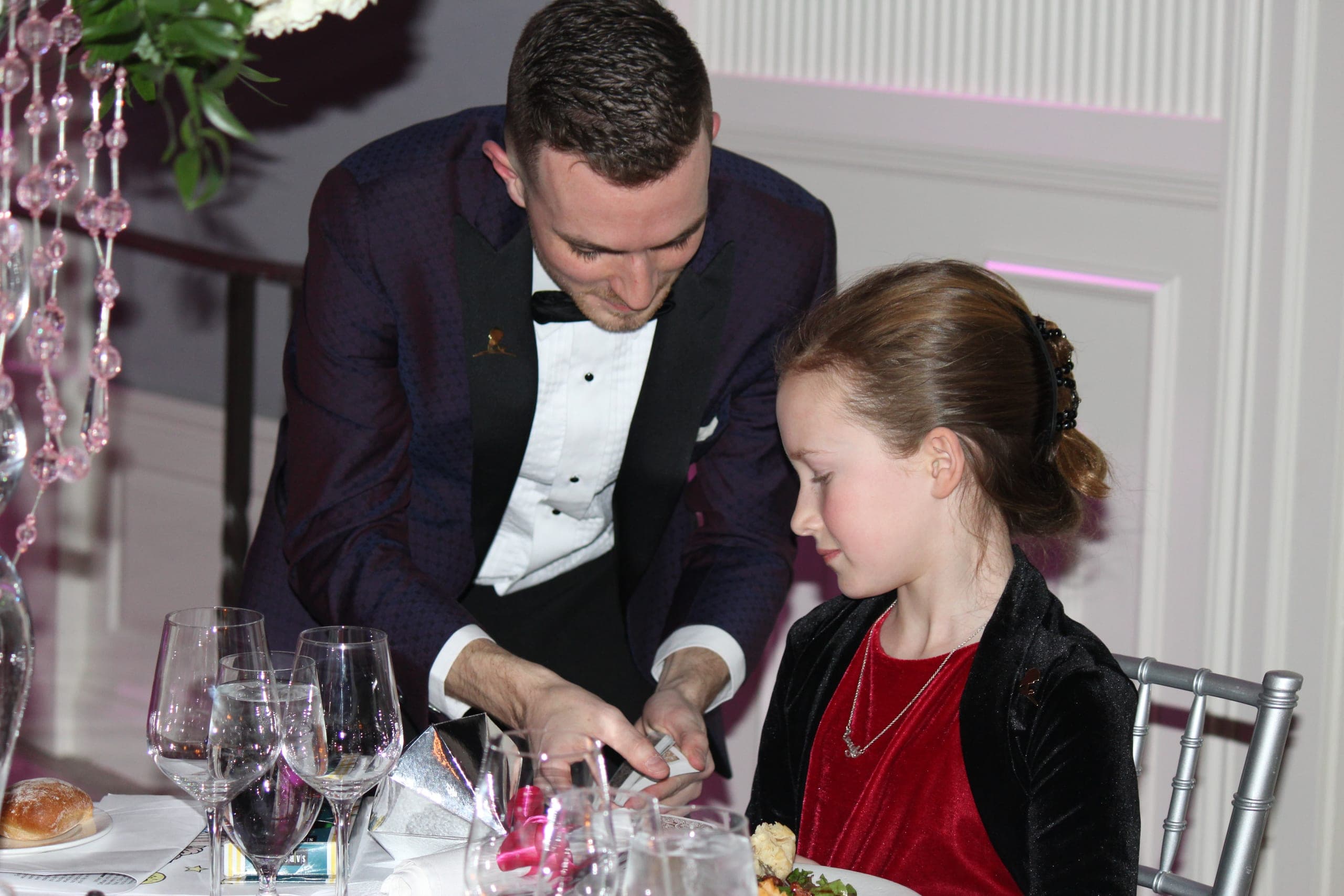 Chris Dare doing close-up card magic for guests