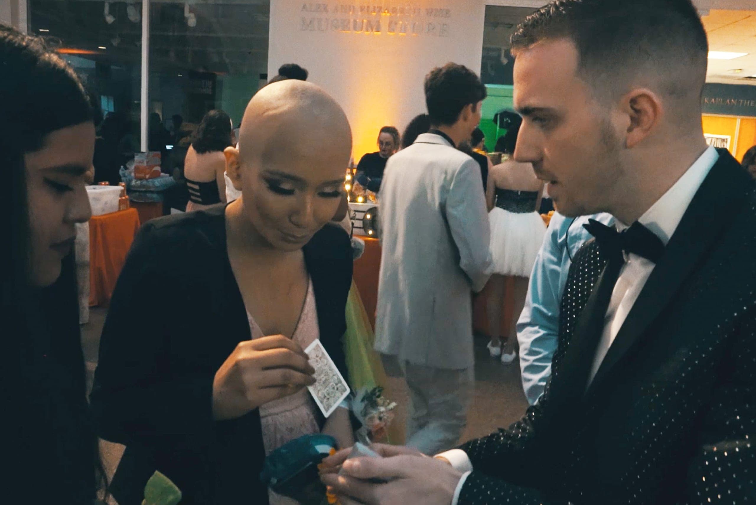 Chris Dare performing close-up magic for guests at a charity event