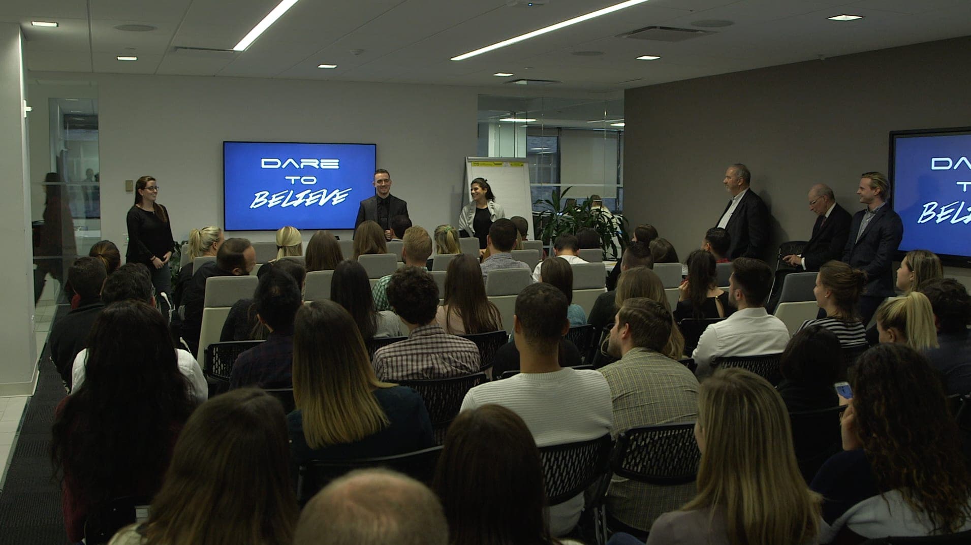Chris Dare presenting his Dare to Believe show to a corporate audience at a client event