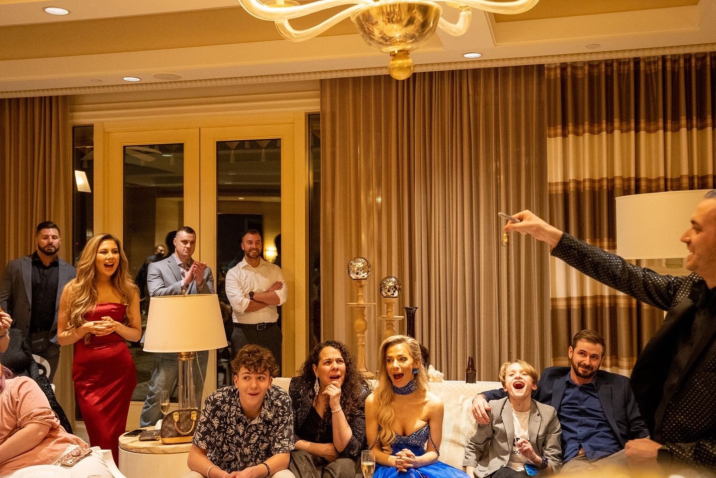 A room of guests reacting during a private suite mentalism show