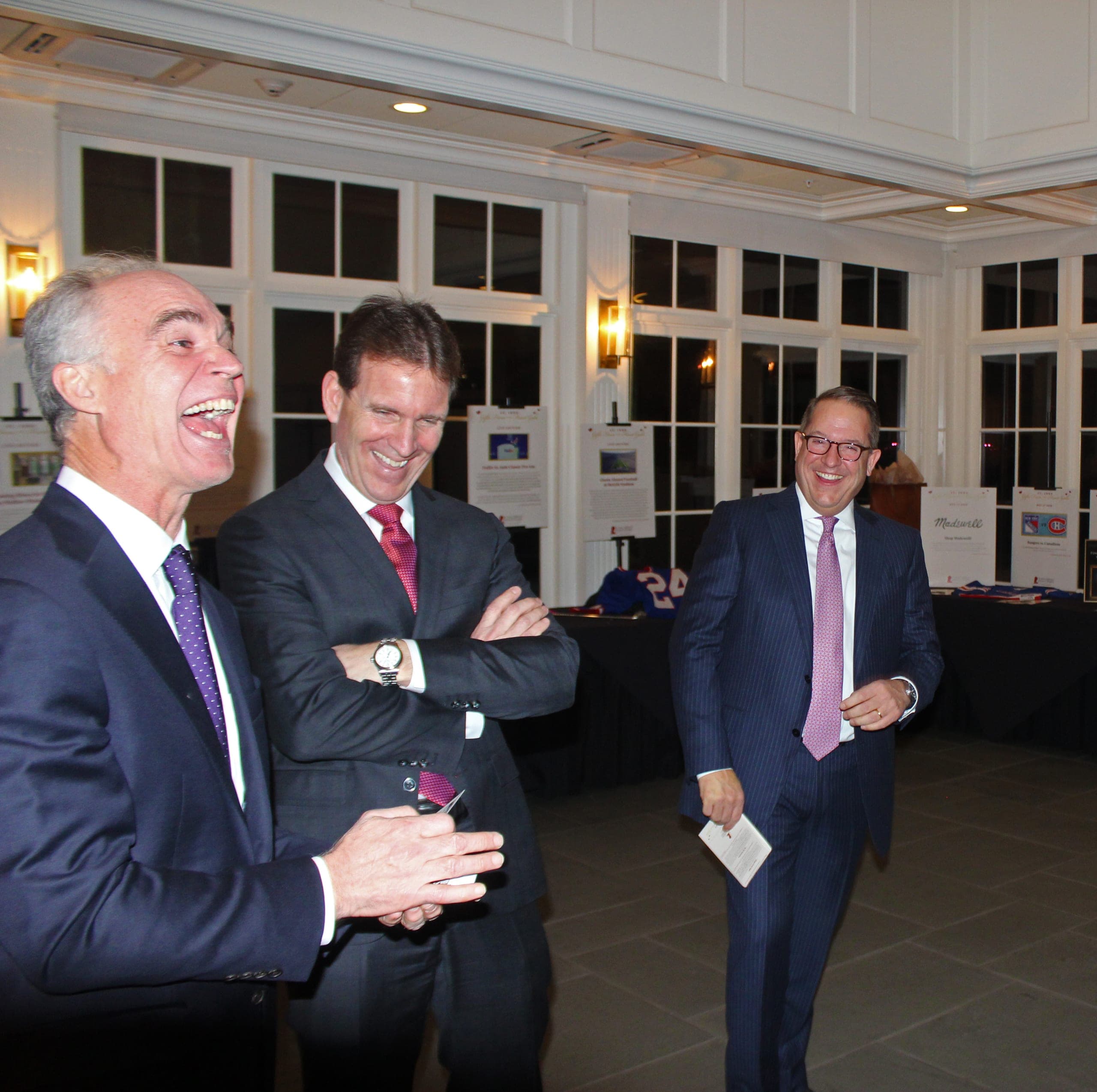 Chris Dare performing card magic for guests in formalwear at a black-tie gala