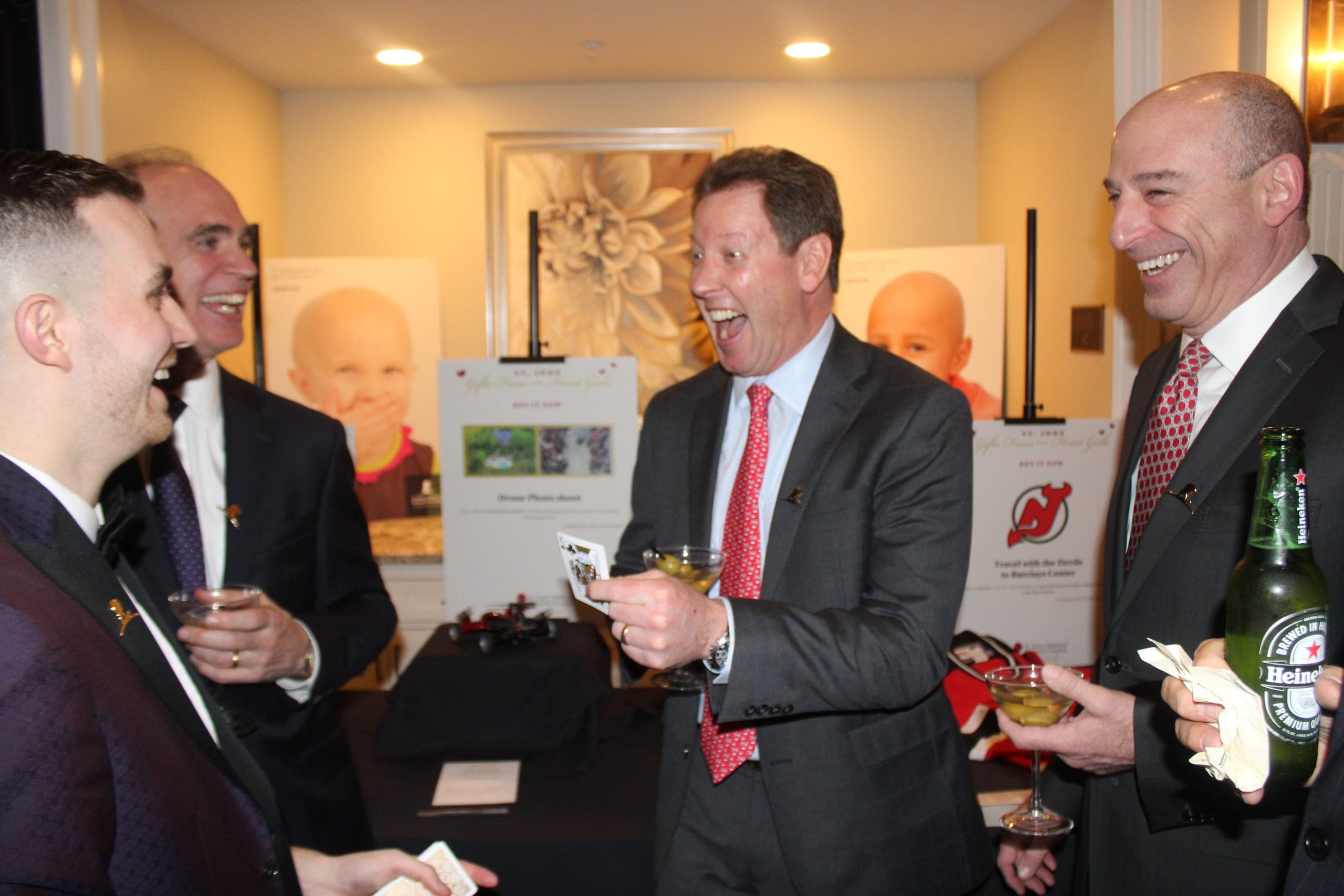 Executives sharing a laugh with Chris Dare at a private event