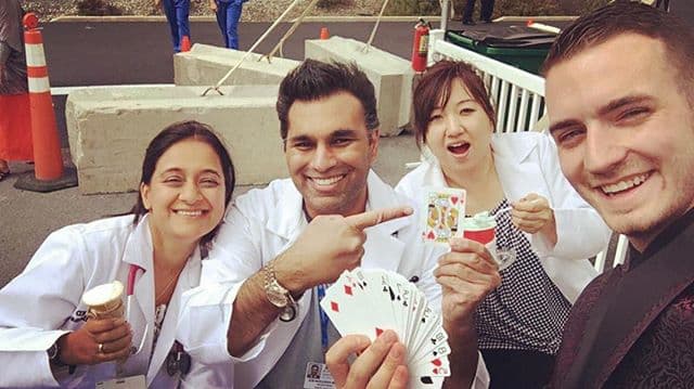 Chris Dare with a group of doctors holding playing cards at Orange Regional Medical Center